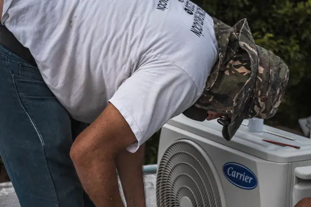 Installer checking the connections on a compact outdoor unit
